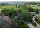 Aerial view showing property lines, landscaping, and proximity to a lake and other homes in the neighborhood at 6084 Masters Blvd, Orlando, FL 32819