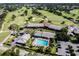 Aerial view of clubhouse amenities featuring a swimming pool, ample parking, and well-maintained landscaping at 6084 Masters Blvd, Orlando, FL 32819