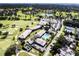Overhead view showcasing the golf course, clubhouse, pool, parking, and lush landscape of the community at 6084 Masters Blvd, Orlando, FL 32819