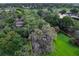 Aerial view of a property with lush trees, landscaping bordered in yellow, next to a golf course at 6084 Masters Blvd, Orlando, FL 32819