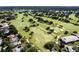 Aerial view of golf course community showcasing manicured greens, sand traps, and surrounding residential area at 6084 Masters Blvd, Orlando, FL 32819