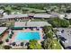 Aerial view of community pool and resort amenities with golf course in the background at 6084 Masters Blvd, Orlando, FL 32819