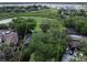 Aerial shot showcasing the property lines, nearby golf course, and mature trees at 6084 Masters Blvd, Orlando, FL 32819