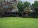 Lush backyard with mature trees, verdant lawn, and peaceful setting at 6084 Masters Blvd, Orlando, FL 32819