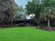 Lush backyard with mature trees, expansive lawn, and relaxing outdoor space at 6084 Masters Blvd, Orlando, FL 32819