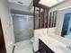 Tidy bathroom featuring a glass shower door, ample vanity space, and a bright, clean atmosphere at 6084 Masters Blvd, Orlando, FL 32819