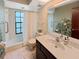 Bathroom featuring a combination of white and dark fixtures, including a vanity and shower-tub combo at 6084 Masters Blvd, Orlando, FL 32819