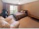 Bedroom featuring a queen bed, a large window for natural light, and minimalist decor at 6084 Masters Blvd, Orlando, FL 32819