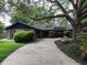 Beautiful home with a welcoming front entrance, well-manicured landscape, and a spacious driveway at 6084 Masters Blvd, Orlando, FL 32819