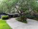 Charming home featuring a circular driveway and mature oak tree providing ample shade at 6084 Masters Blvd, Orlando, FL 32819