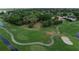 Aerial view of a golf course with pond, bunkers, and manicured greenways in a well kept community at 6084 Masters Blvd, Orlando, FL 32819