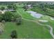 Aerial view of a golf course with pond, bunkers, and manicured greenways in a well kept community at 6084 Masters Blvd, Orlando, FL 32819