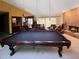 Spacious living room featuring a billiard table, comfortable seating, and a cozy fireplace at 6084 Masters Blvd, Orlando, FL 32819