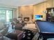 Cozy living room with a brick fireplace, comfortable leather seating, and a pool table for indoor fun at 6084 Masters Blvd, Orlando, FL 32819