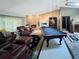 Large living area featuring a fireplace, leather furniture, and a pool table, perfect for relaxing at 6084 Masters Blvd, Orlando, FL 32819