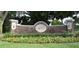 Stone and stucco Bay Hill neighborhood sign surrounded by colorful flowers and lush greenery at 6084 Masters Blvd, Orlando, FL 32819