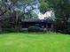 Charming home featuring a screened-in porch surrounded by lush greenery and a well-maintained lawn at 6084 Masters Blvd, Orlando, FL 32819
