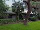 The home has mature trees and established plantings providing shade and privacy at 6084 Masters Blvd, Orlando, FL 32819