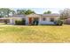 Charming single-story home with a well-maintained front yard and bright orange front door at 730 Georgia Ave, Longwood, FL 32750