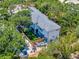 Aerial view of home showcasing backyard, outdoor patio, fence, and mature trees at 804 E 24Th Ave, New Smyrna Beach, FL 32169