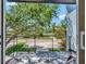 Balcony with black metal railing featuring tile flooring and views of mature tree and roadway at 804 E 24Th Ave, New Smyrna Beach, FL 32169