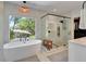 Luxurious bathroom with a freestanding tub, glass-enclosed shower, and modern fixtures at 804 E 24Th Ave, New Smyrna Beach, FL 32169