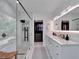 Stylish bathroom with a glass-enclosed shower, double vanity, and a well-organized walk-in closet at 804 E 24Th Ave, New Smyrna Beach, FL 32169