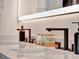 This bathroom vanity features a double sink and stylish black fixtures with quartz countertops at 804 E 24Th Ave, New Smyrna Beach, FL 32169