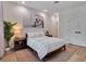 Bedroom with light wood floors, neutral walls, a bed with white comforter and a piece of art at 804 E 24Th Ave, New Smyrna Beach, FL 32169
