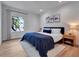 Bright bedroom with wood floors, a blue comforter, white walls and lots of natural light at 804 E 24Th Ave, New Smyrna Beach, FL 32169