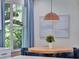 Dining room with views out the window, a round wood table, and modern furnishings at 804 E 24Th Ave, New Smyrna Beach, FL 32169