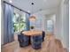Dining area featuring a round wood table, four upholstered chairs, and a light fixture at 804 E 24Th Ave, New Smyrna Beach, FL 32169