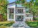 Inviting modern two-story home featuring a balcony and manicured front lawn at 804 E 24Th Ave, New Smyrna Beach, FL 32169