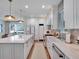 Modern kitchen featuring an island, updated appliances, and sleek white cabinetry at 804 E 24Th Ave, New Smyrna Beach, FL 32169