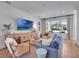 A living room boasts a blue sofa, light wood furniture, and bright natural light at 804 E 24Th Ave, New Smyrna Beach, FL 32169