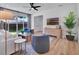 A living room has sliding glass doors, a TV, light wood furniture, and bright natural light at 804 E 24Th Ave, New Smyrna Beach, FL 32169