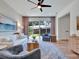 Bright living room featuring a ceiling fan, modern furniture, and sliding glass doors to the backyard at 804 E 24Th Ave, New Smyrna Beach, FL 32169