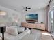 Comfortable living room featuring modern furniture, stylish decor, and a large flat screen television at 804 E 24Th Ave, New Smyrna Beach, FL 32169