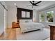 Serene main bedroom featuring a accent wall, ceiling fan, and natural light at 804 E 24Th Ave, New Smyrna Beach, FL 32169