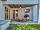 Covered patio with sleek seating, ceiling fan, television, and barbecue grill overlooking backyard at 804 E 24Th Ave, New Smyrna Beach, FL 32169