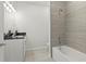 Bathroom featuring bathtub with tiled wall and white vanity with dark countertop at 805 S Locust Ave, Sanford, FL 32771