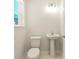Small bathroom features a toilet and sink with pedestal at 805 S Locust Ave, Sanford, FL 32771