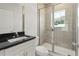 Modern bathroom with tiled shower, glass door, granite countertop and white vanity at 805 S Locust Ave, Sanford, FL 32771