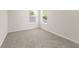 Neutral bedroom with carpet, white walls, and two windows offering natural light at 805 S Locust Ave, Sanford, FL 32771