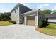Two-story home with a one car garage and a patterned brick driveway at 805 S Locust Ave, Sanford, FL 32771