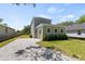 A charming two-story home features a one-car garage with a patterned brick driveway at 805 S Locust Ave, Sanford, FL 32771