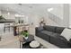 Open living space with a modern kitchen, dining area, and stylish furniture, bathed in natural light at 805 S Locust Ave, Sanford, FL 32771