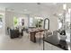 Bright, open-concept living space with modern furniture, a dining area, and a view of the kitchen at 805 S Locust Ave, Sanford, FL 32771