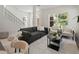 Sun-filled living room with neutral tones, modern furniture, and large windows offering natural light at 805 S Locust Ave, Sanford, FL 32771