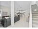 Bright open-concept living area with modern decor, tile floors, and easy access to the staircase at 805 S Locust Ave, Sanford, FL 32771